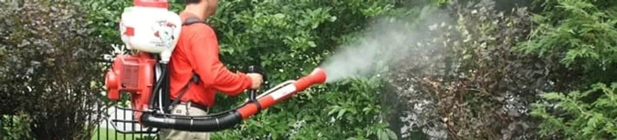 Mosquito control technician fogging shrubs and landscaping for mosquito treatment in San Francisco, CA
