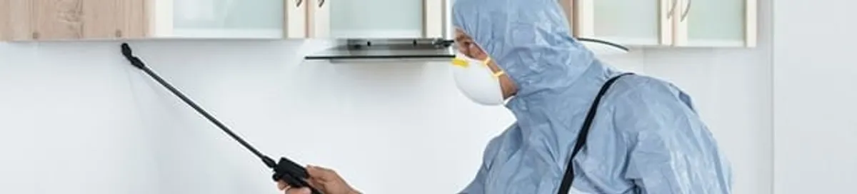 Termite treatment technician applying indoor pest control spray in San Francisco, CA